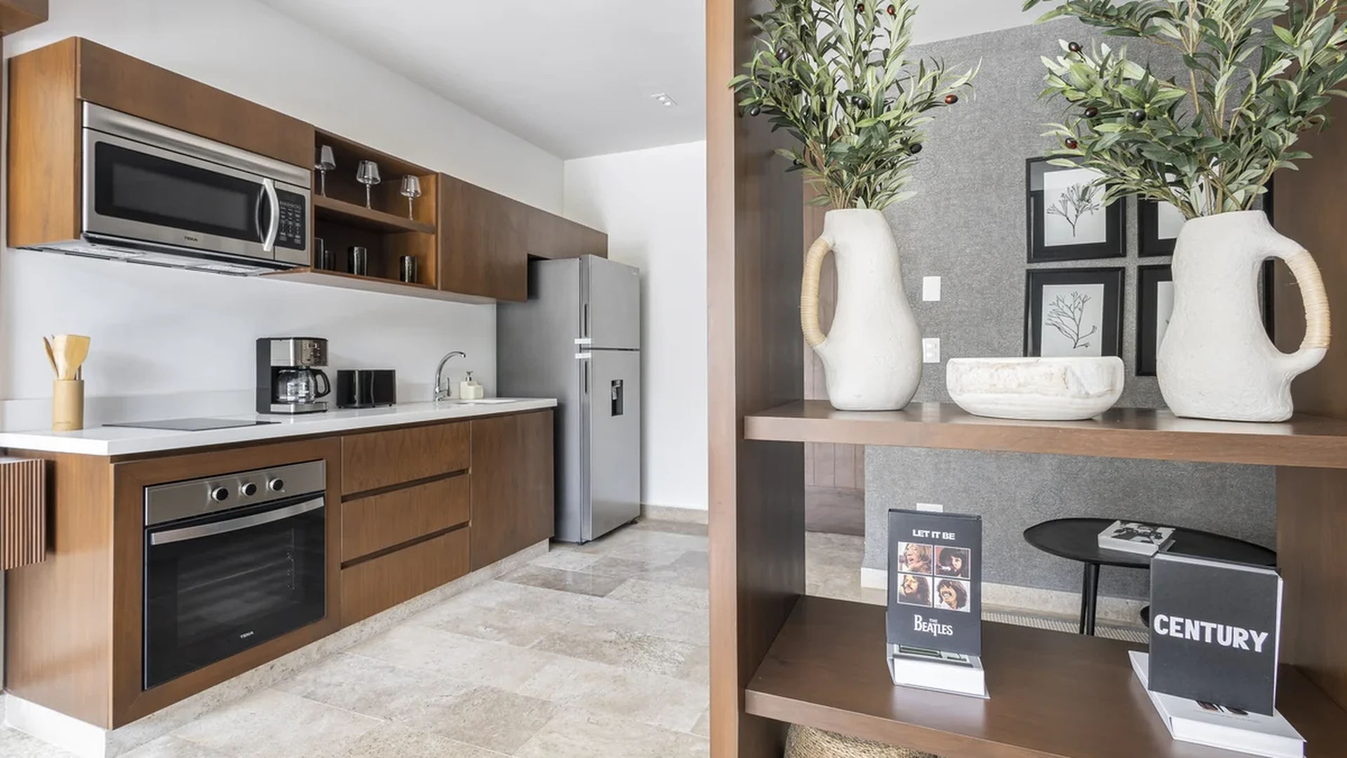 View of Modern Kitchen at Peregrina, showcasing Stainless Steel Appliances, Wood Cabinetry.