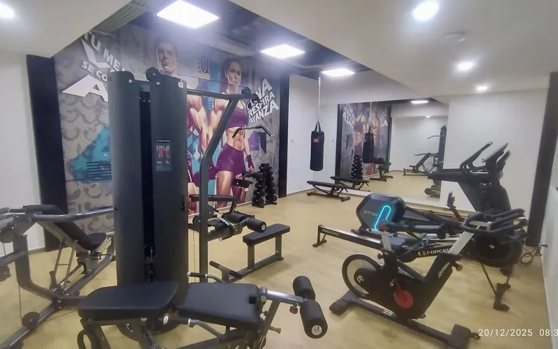 A collection of interior and exterior photographs showcasing the finished common areas and amenities of Quartier 75, including a stylish lobby lounge with contemporary furniture, a fully equipped modern gym with various exercise machines, a serene...