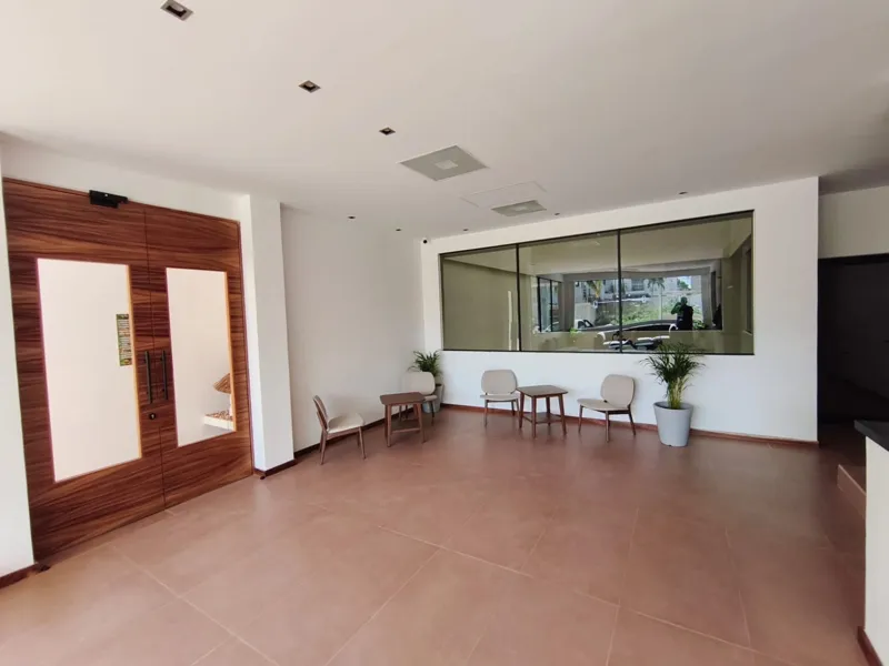 A collection of interior and exterior photographs showcasing the finished common areas and amenities of Quartier 75, including a stylish lobby lounge with contemporary furniture, a fully equipped modern gym with various exercise machines, a serene...