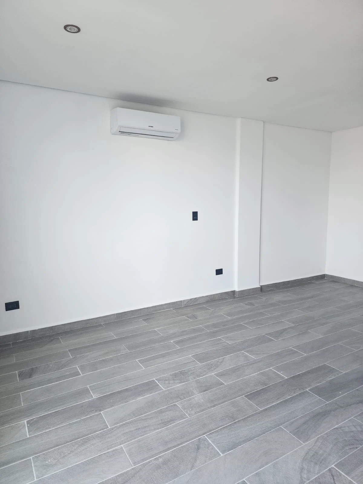 View of Empty Room at Serenata, showcasing Unfurnished Interior, Modern Design.