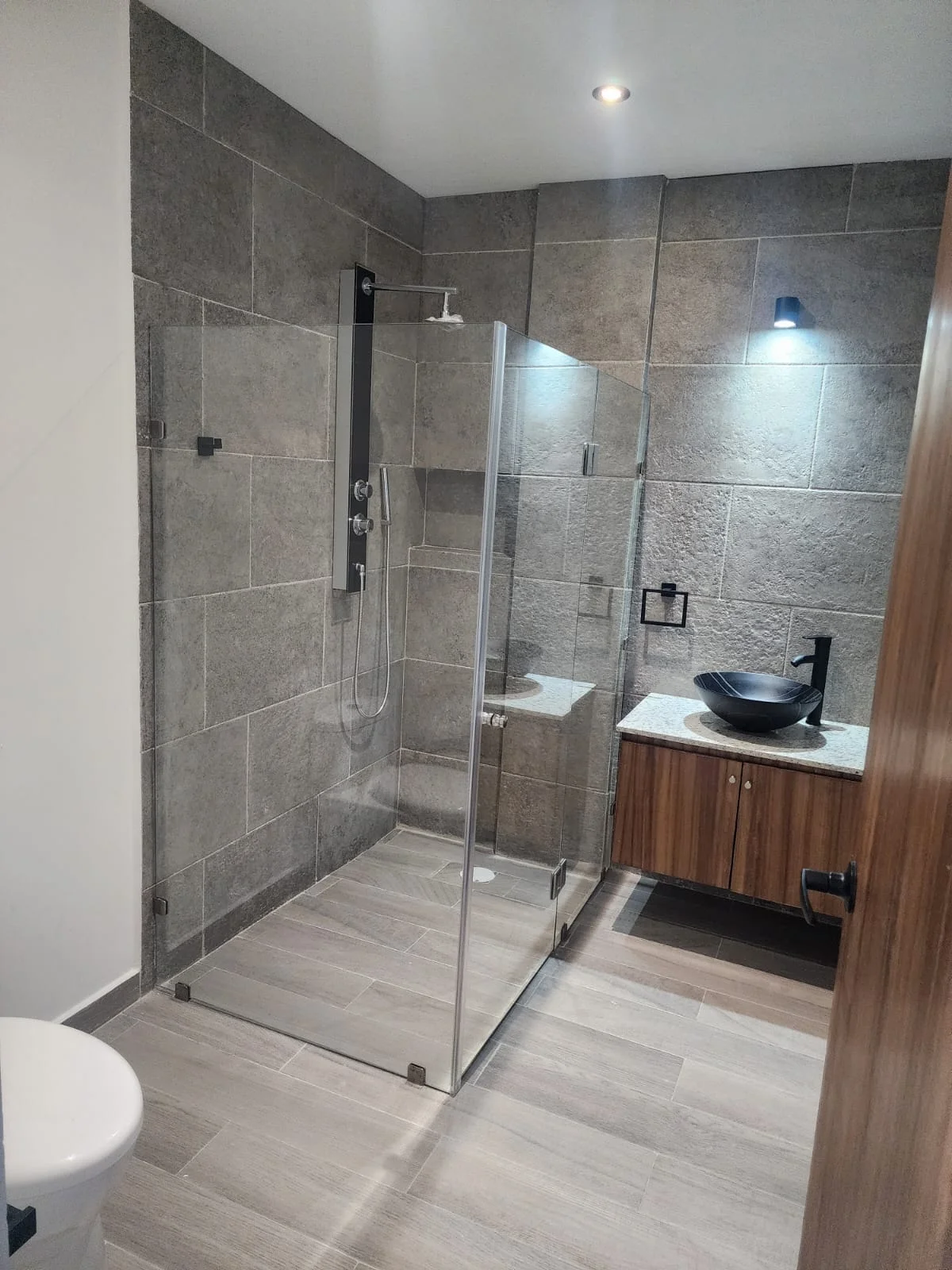 View of Modern Bathroom at Serenata, showcasing Glass Shower, Rainfall Shower.