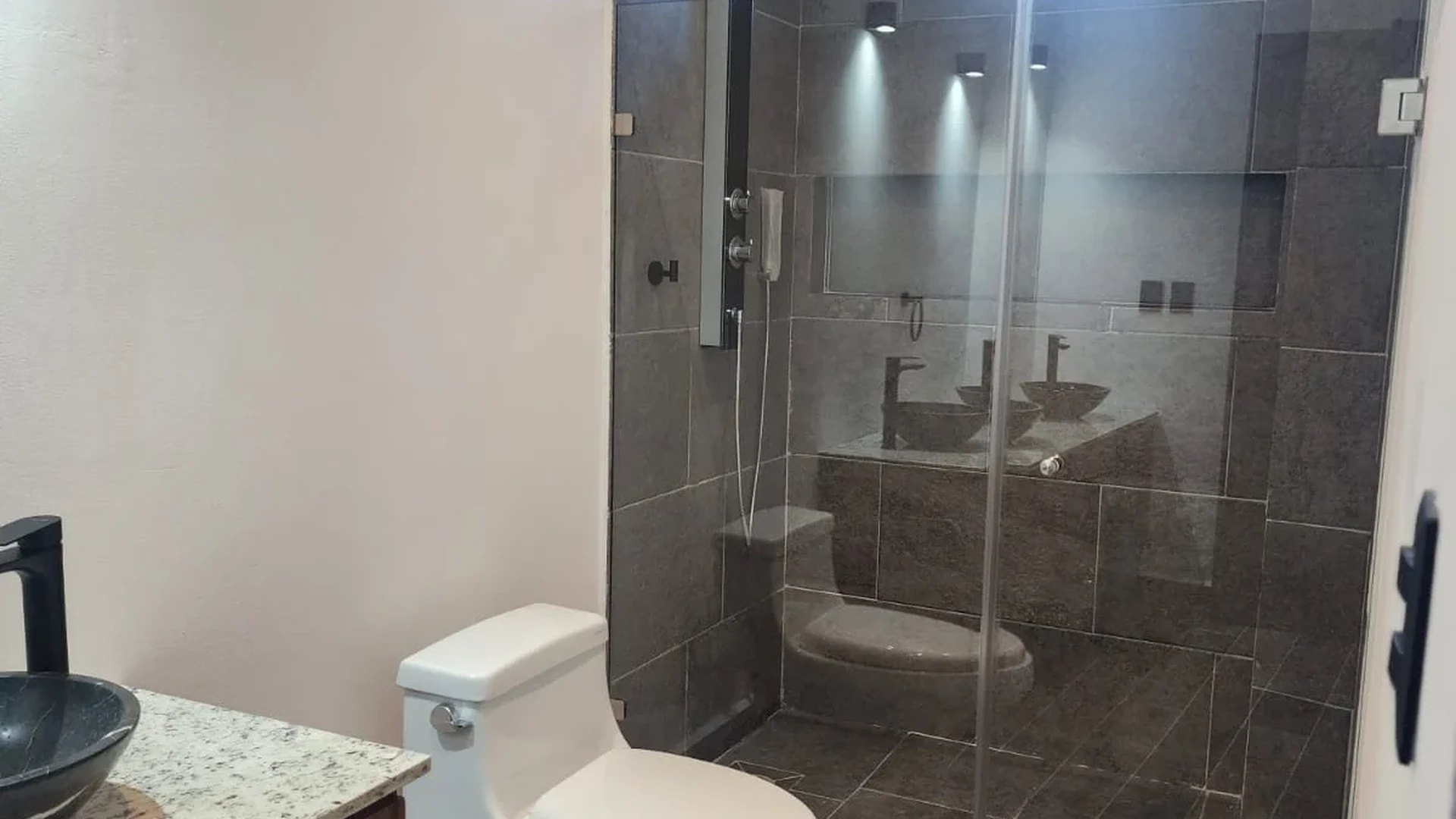 View of Modern Bathroom at Serenata, showcasing Contemporary Design, Glass Shower.