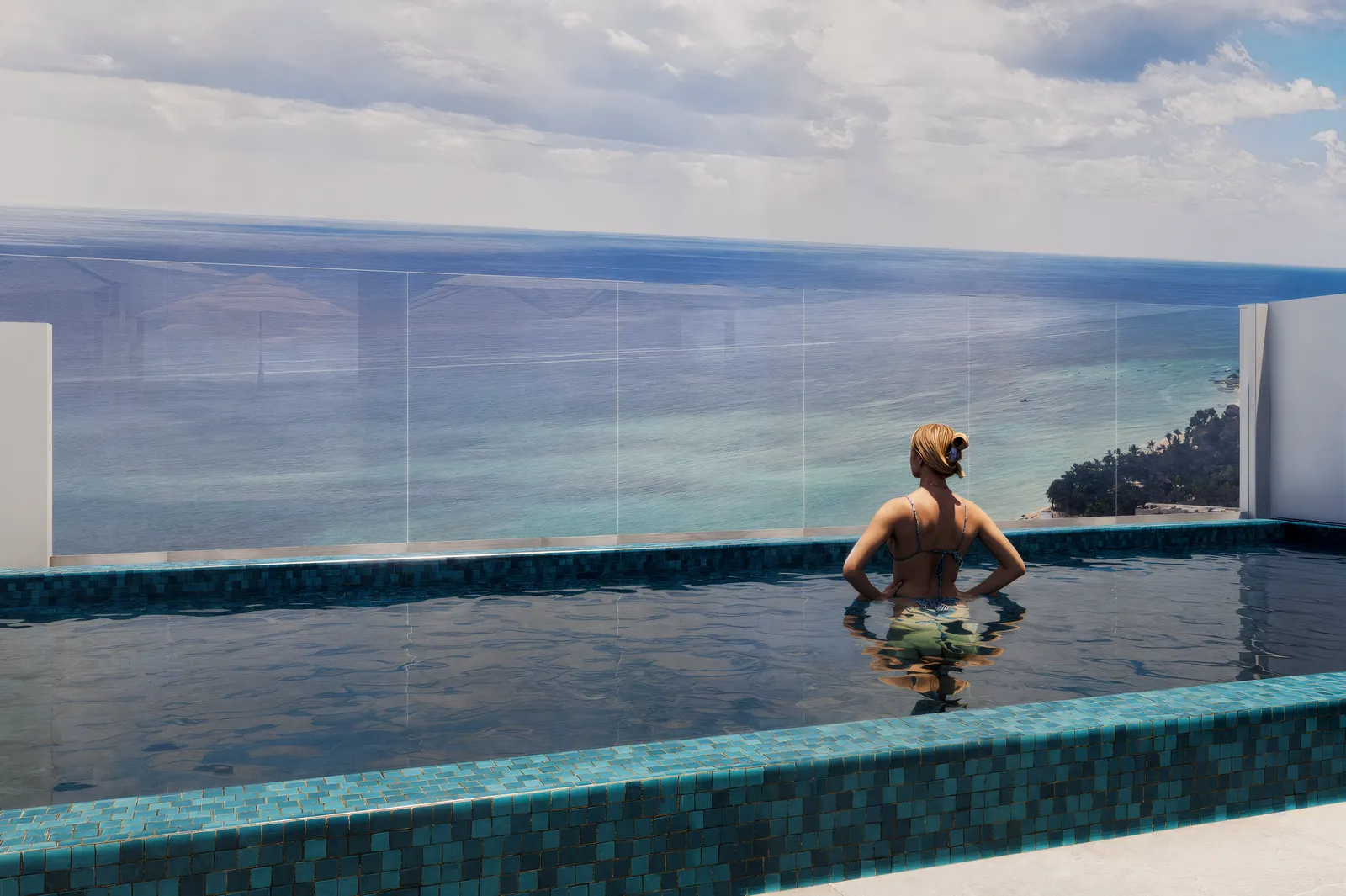 Pool with glass railing overlooking the ocean
