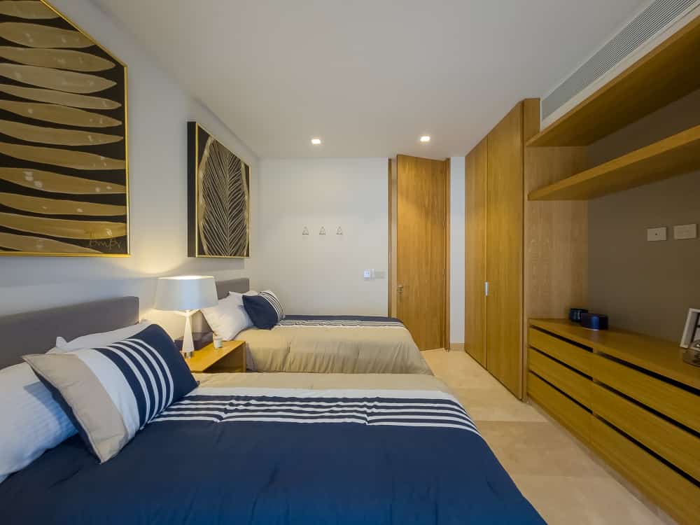 Bedroom with twin beds and wooden wardrobe