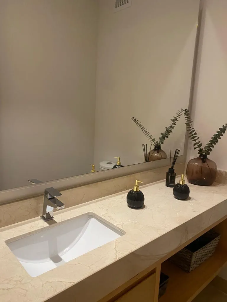 Bathroom vanity with white sink and large mirror