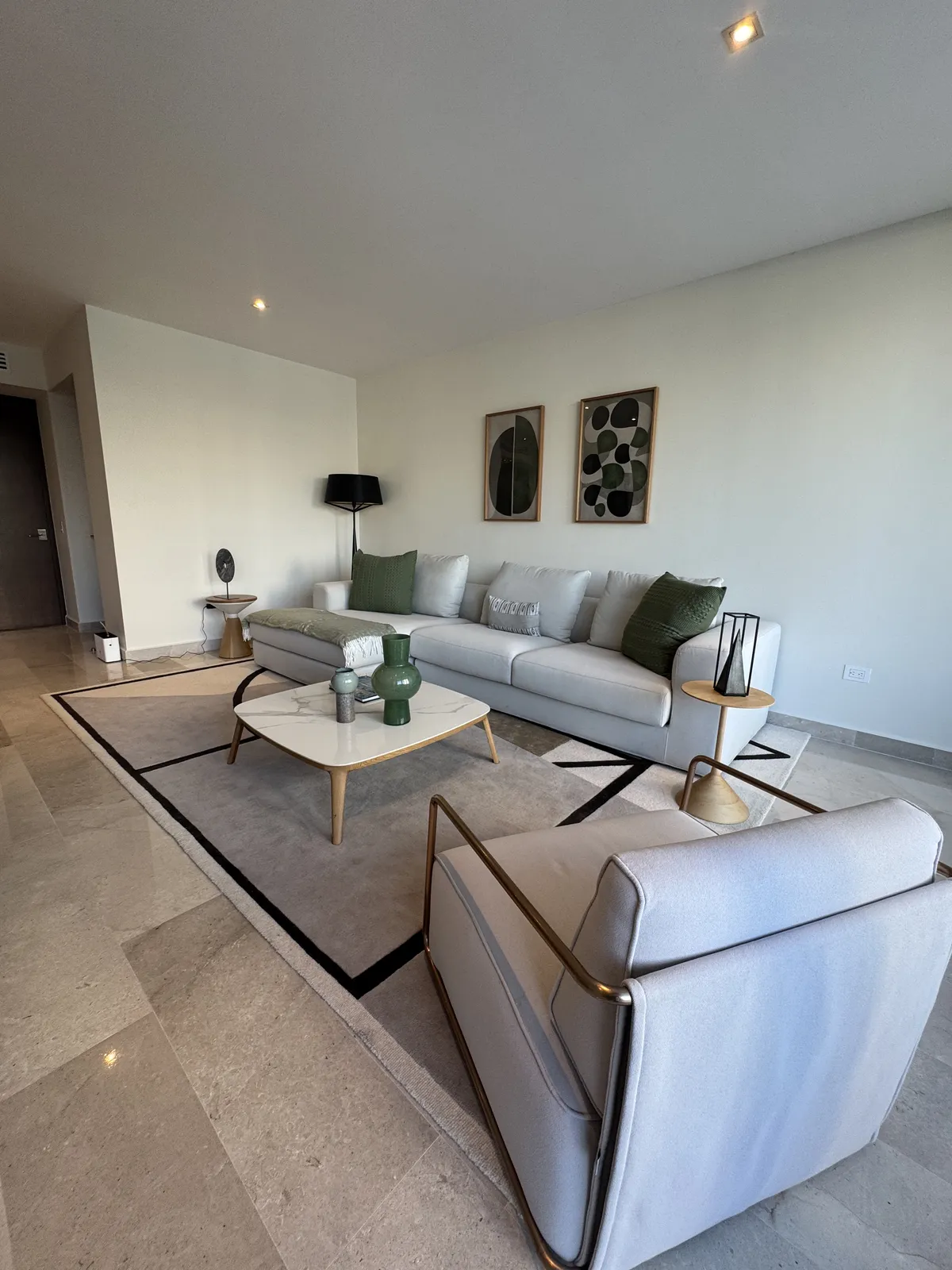 Modern living room with grey sofa, coffee table, and abstract art