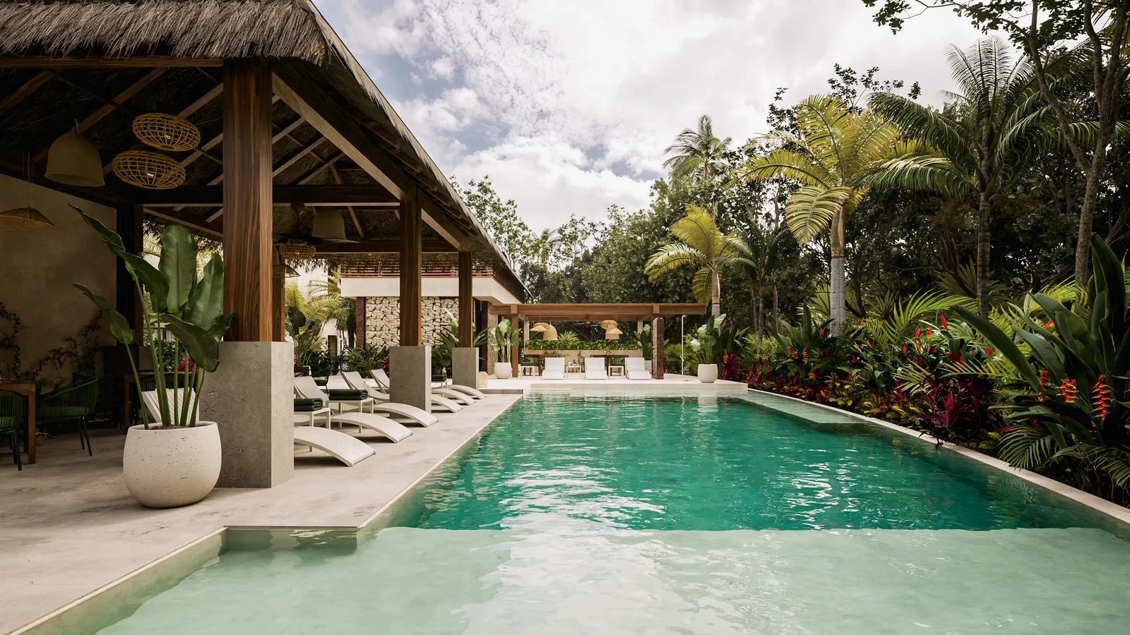 Swimming pool with lounge chairs and tropical vegetation.