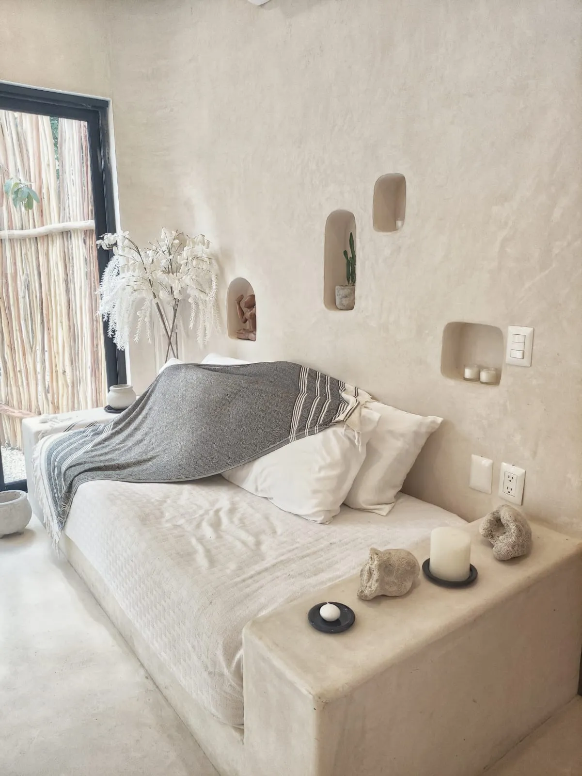 Bedroom with textured walls and built-in niches