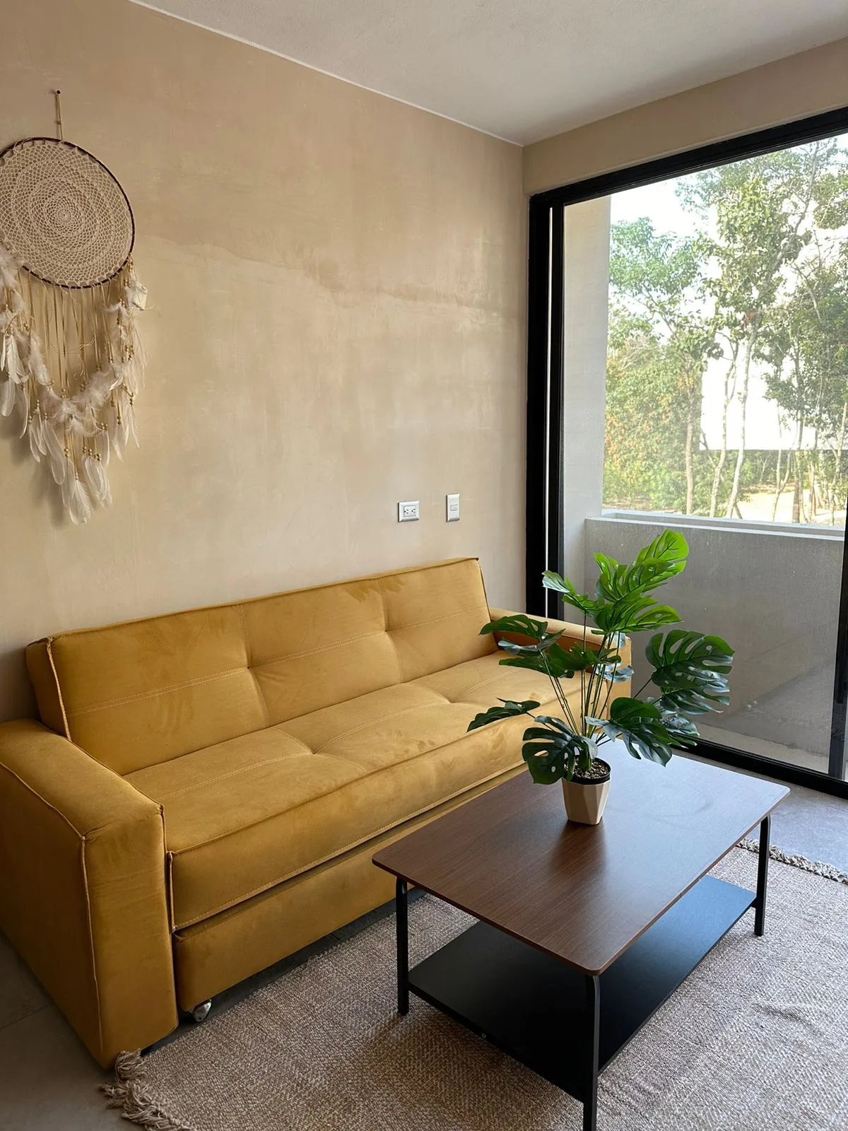 Living room with yellow sofa and balcony view