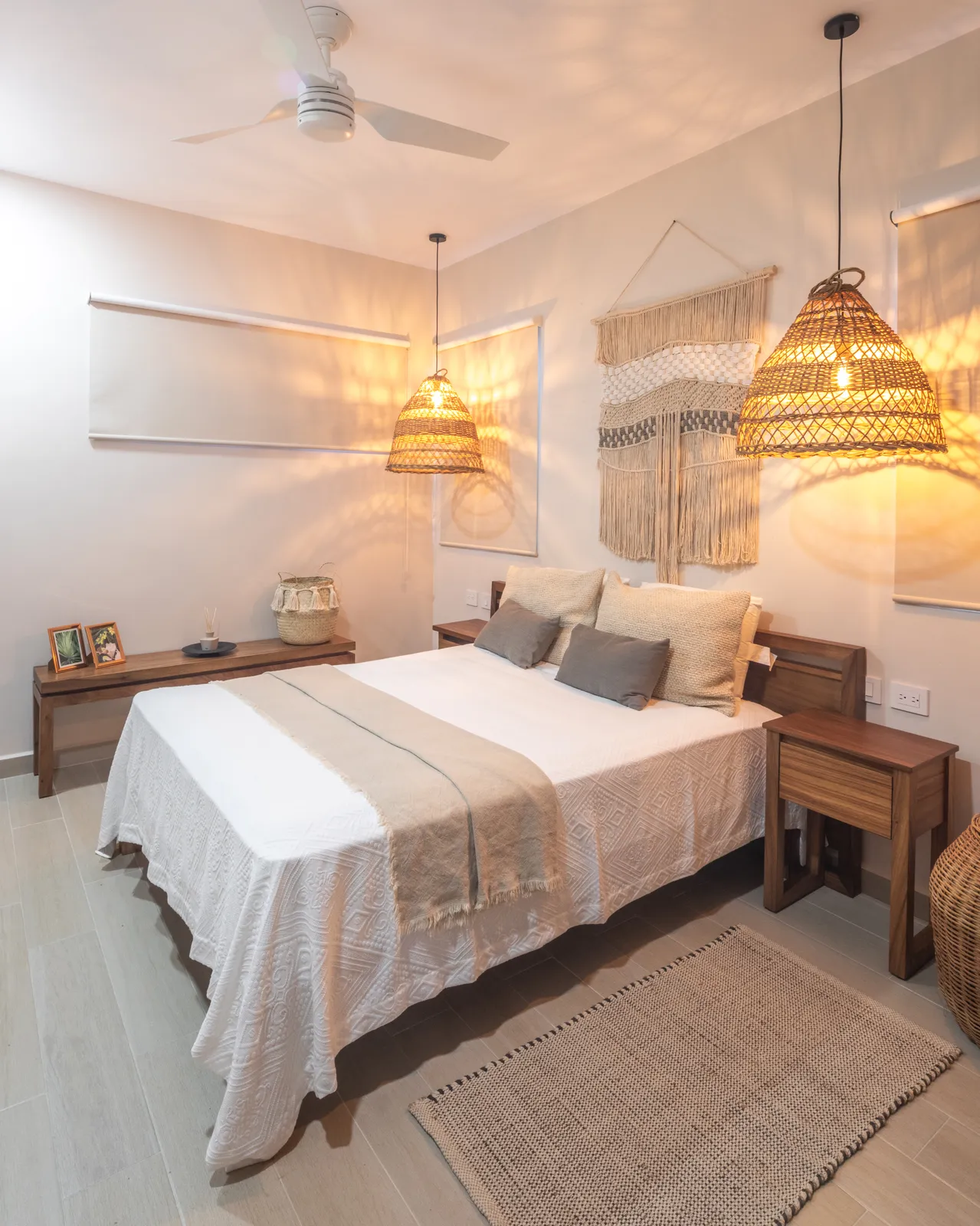 Bedroom with wooden furniture and woven pendant lights