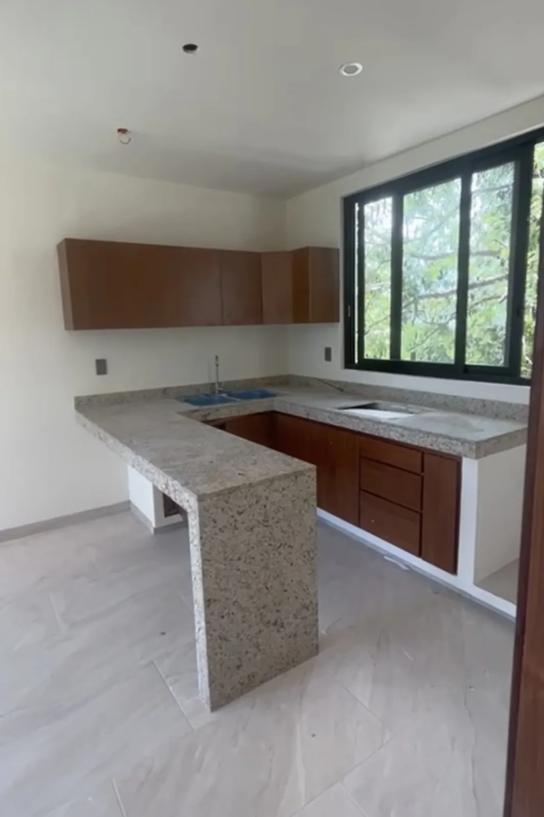 Modern kitchen with wooden cabinets and stone countertop
