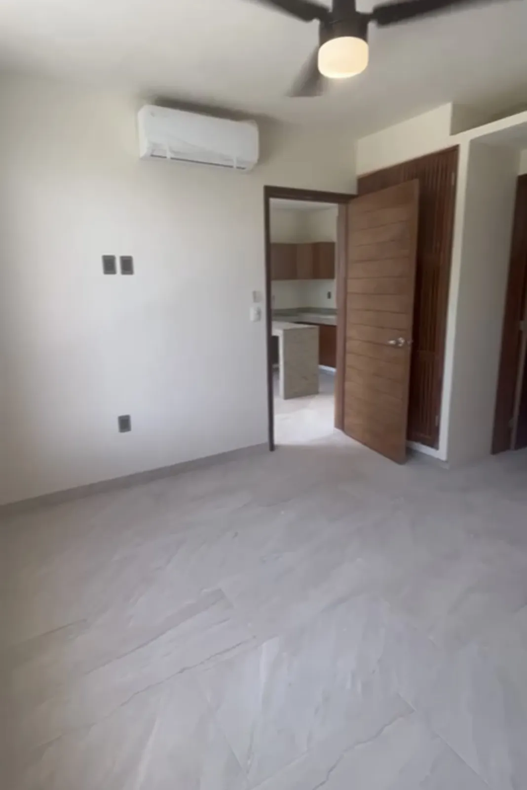 Empty interior room with white walls and tile flooring
