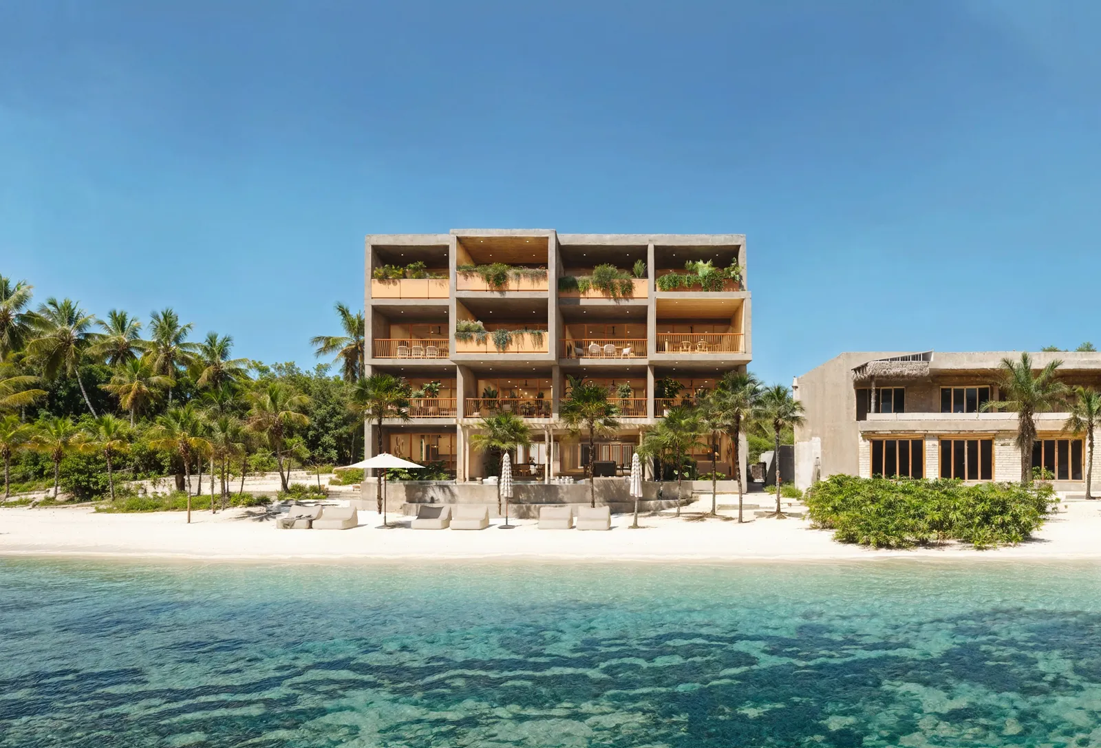 Modern beachfront building with balconies and palm trees