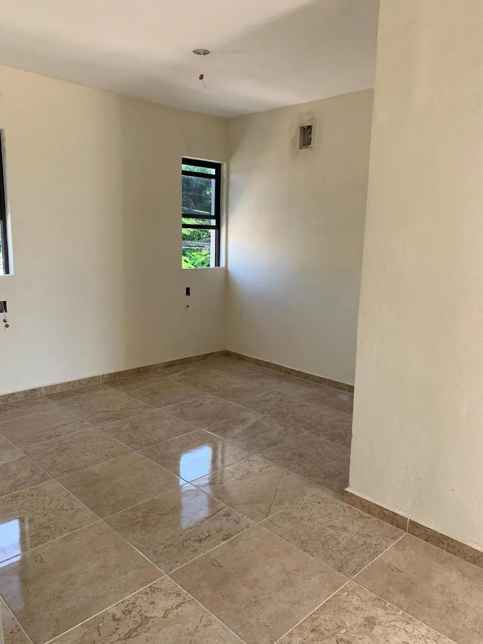 Unfinished room with tiled floor and exposed electrical wiring