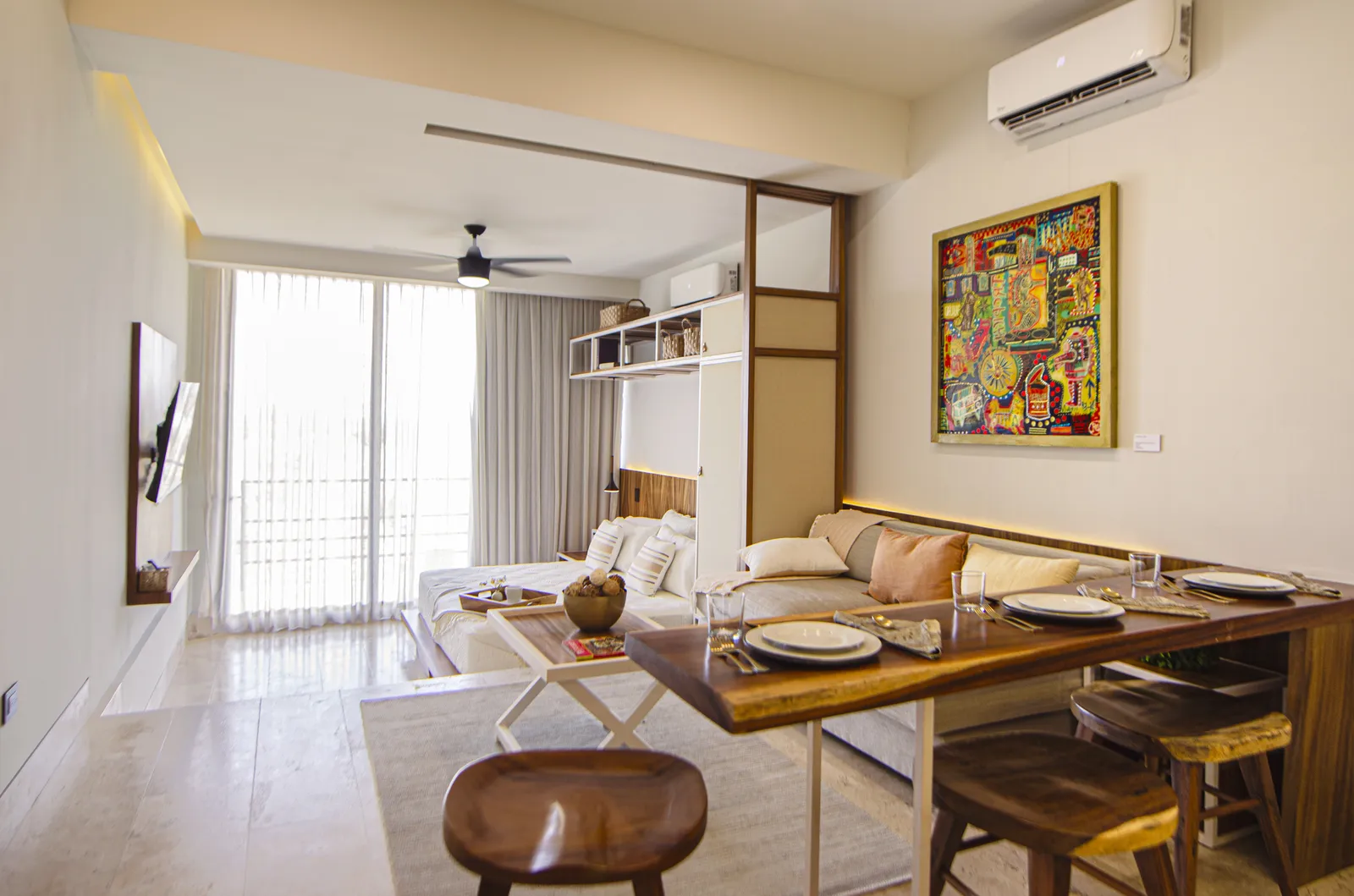 Furnished studio apartment with dining table and bed