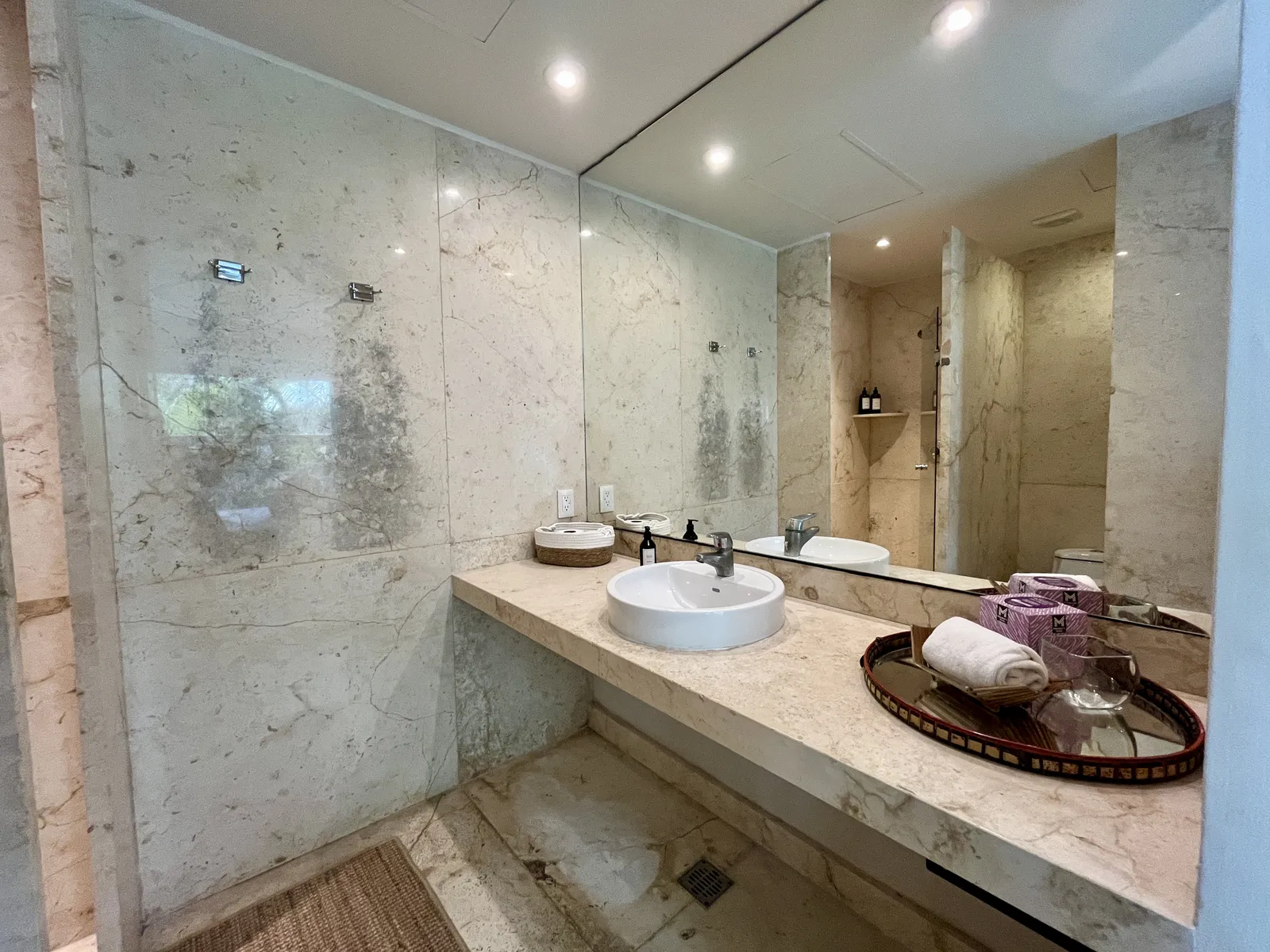 Bathroom with marble walls and vessel sink