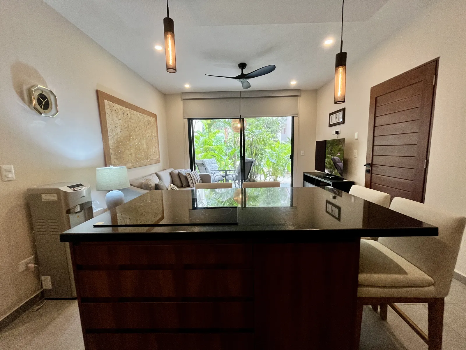 Furnished living and kitchen area with island and patio view