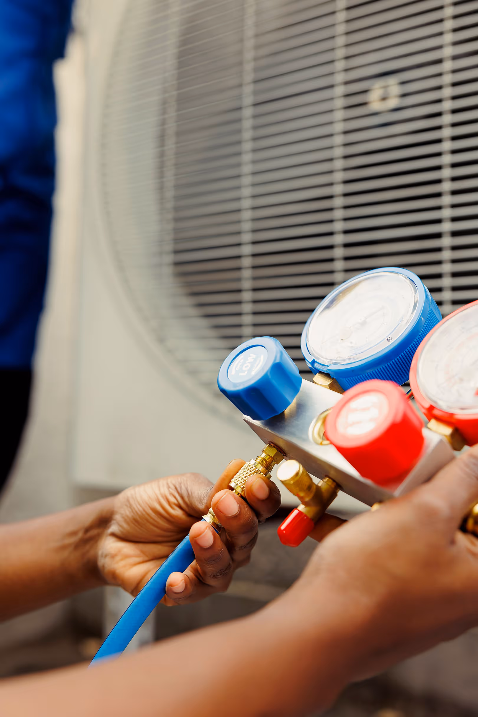 Hands adjusting gas on a refrigeration unit