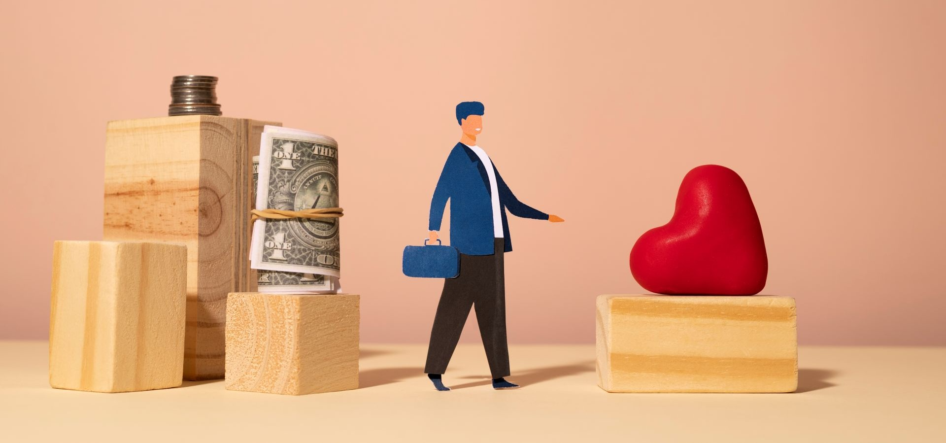 Figura de empresario equilibrando entre bloques con dinero y corazón rojo