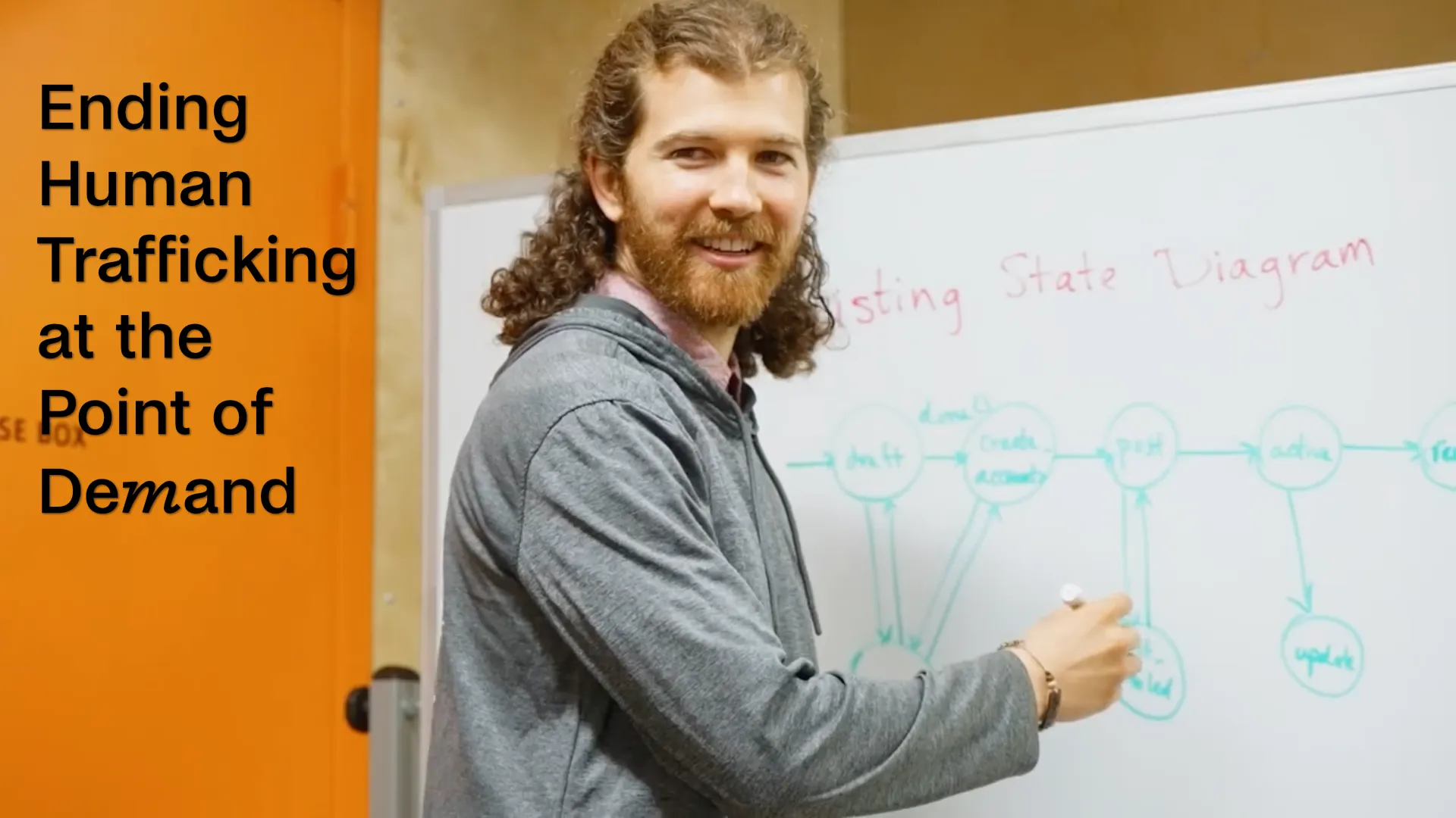 An image of a man writing on a whiteboard.
