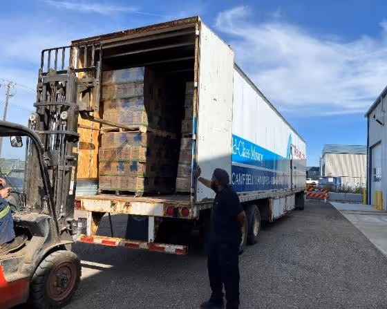 A person standing next to a truck