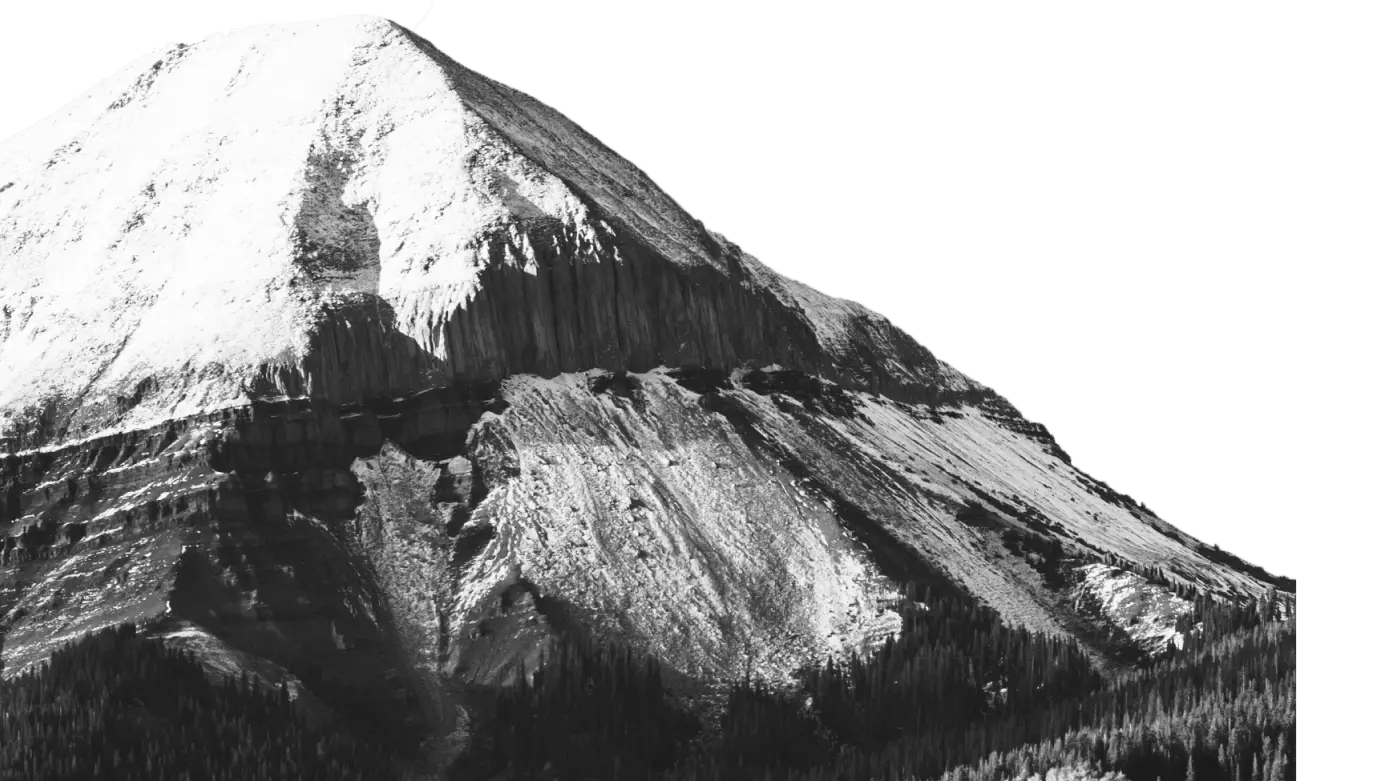 Dramatic black and white image of a snow-covered mountain peak, representing strength, stability, and long-term vision at Colorado Wealth Group