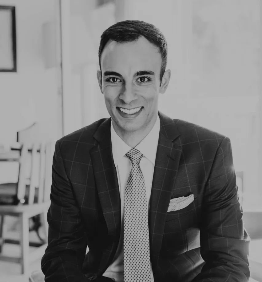 Keah K, a client of Colorado Wealth Group, smiling in a professional business suit, showcasing confidence and satisfaction with customized financial planning services.