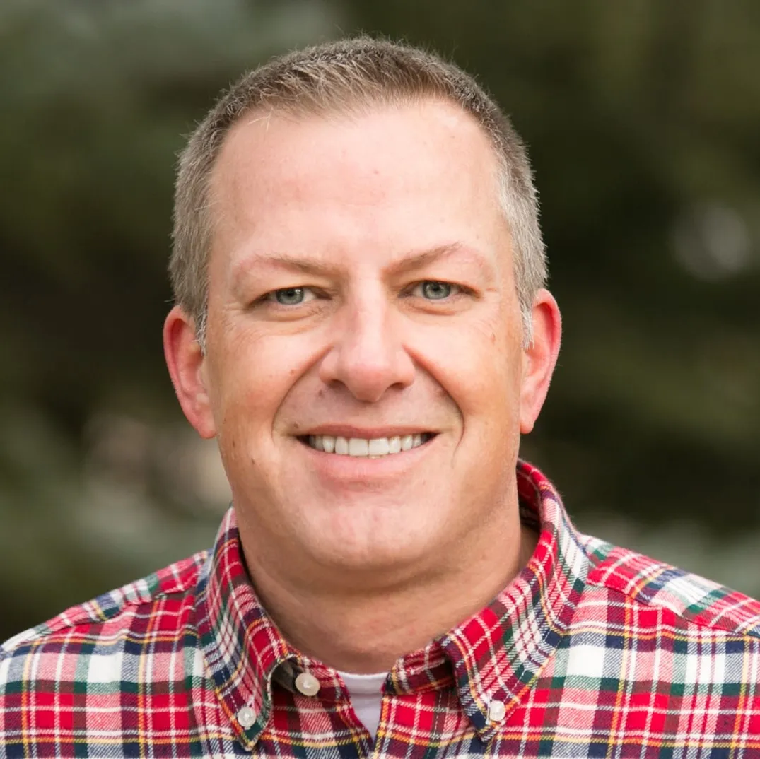 Brian, a satisfied client of Colorado Wealth Group, smiling confidently in an outdoor setting, reflecting financial security and personalized planning success.