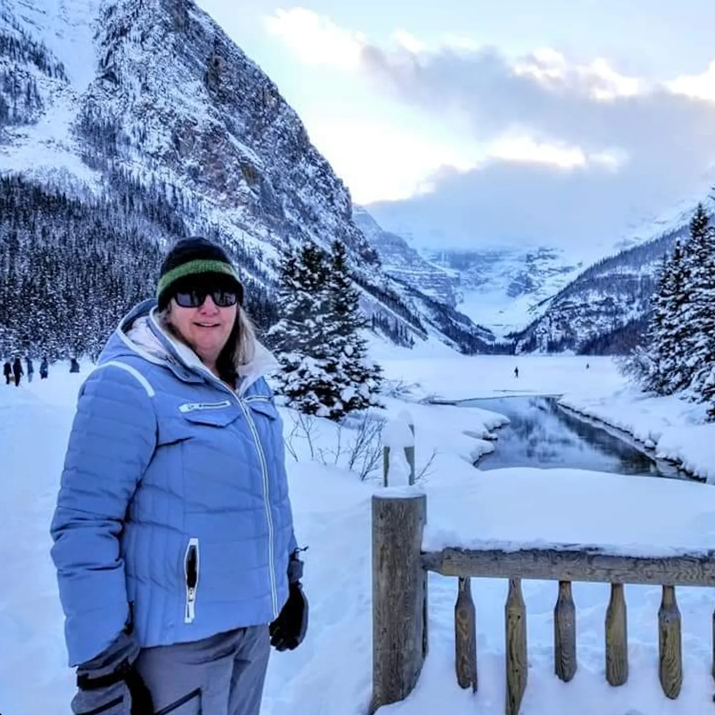 JuliC, a Colorado Wealth Group client, enjoying a snowy mountain landscape on a winter vacation, symbolizing the financial freedom and peace of mind achieved through expert planning.