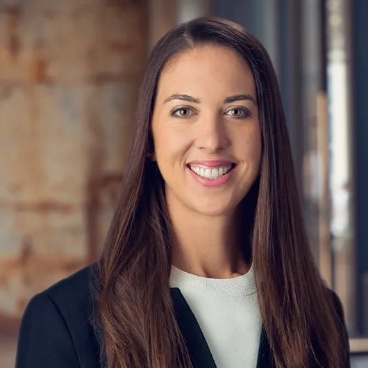 Professional portrait of Steena, a satisfied client of Colorado Wealth Group, smiling in a business setting to reflect financial confidence and trust in expert financial planning services.