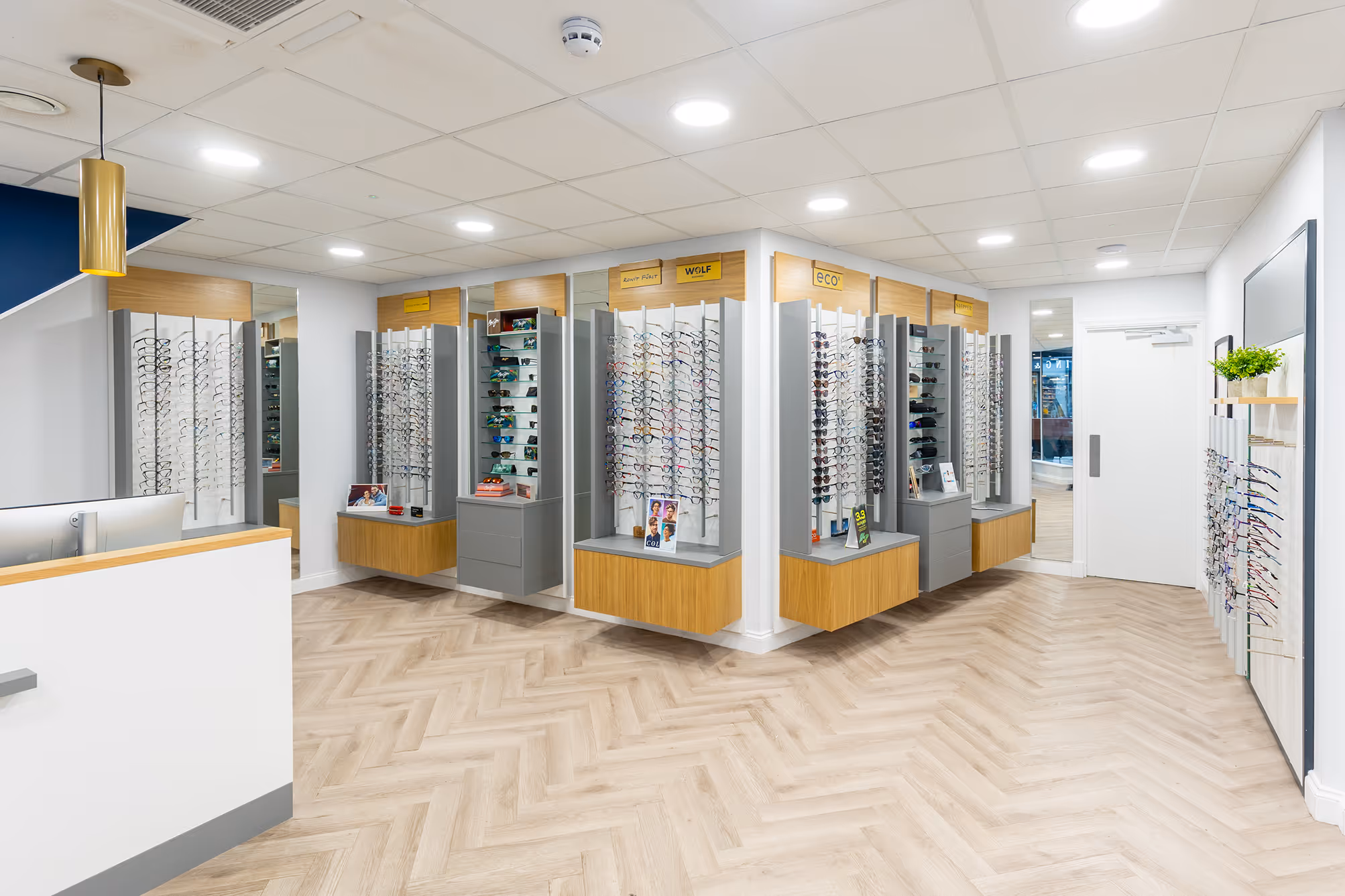 Modern eyewear store with multiple display cases of glasses and sunglasses