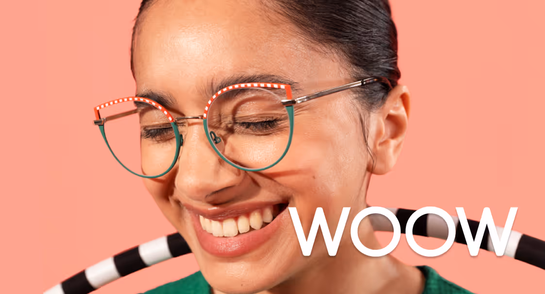 Smiling person with glasses against pink background, with 'WOW' text