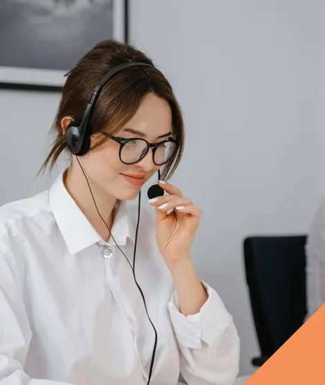 A woman with a headset answering a support call.