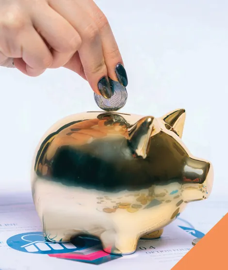 Person putting saved money in piggy bank