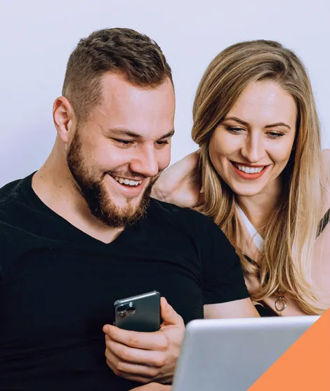 Happy Couple looking at laptop, seeing a positive result. 