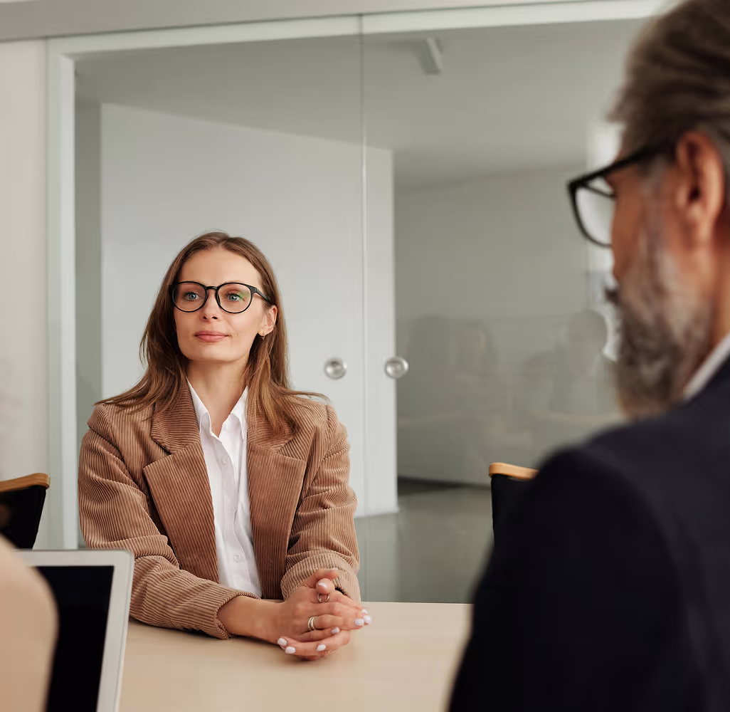 Content pretty woman being interviewed in a simplistic office setting