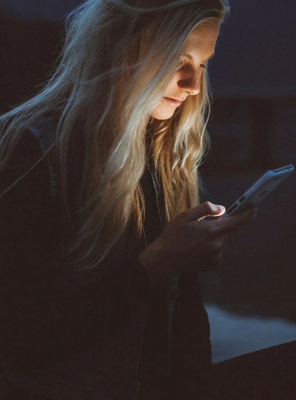 Lifestyle photograph of a woman engaging with an interactive digital AMP story from Velvet Magazine on her smartphone.