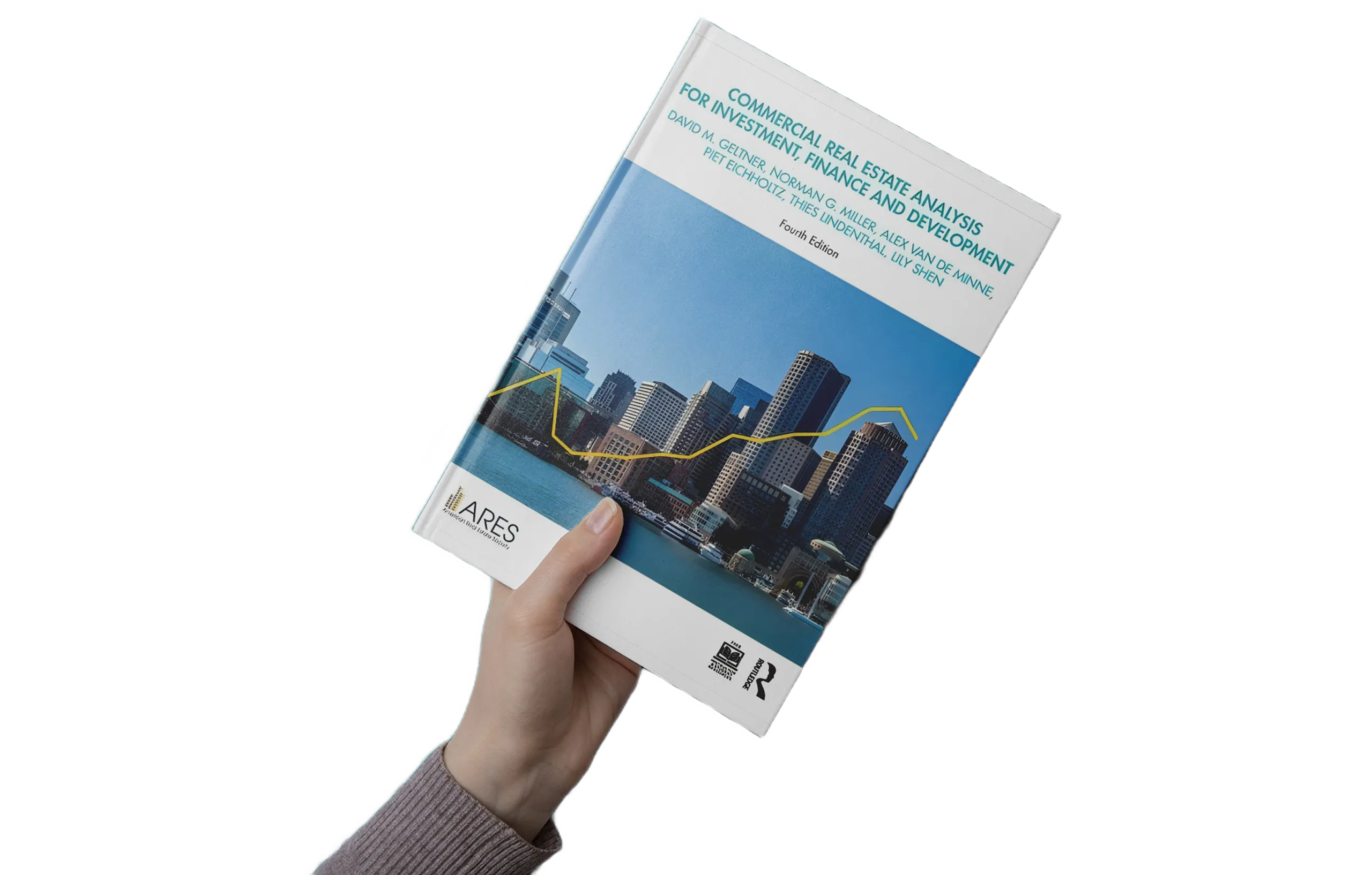 Hand holding the book “Commercial Real Estate Analysis for Investment, Finance and Development” with a city skyline cover and yellow trend line graph.
