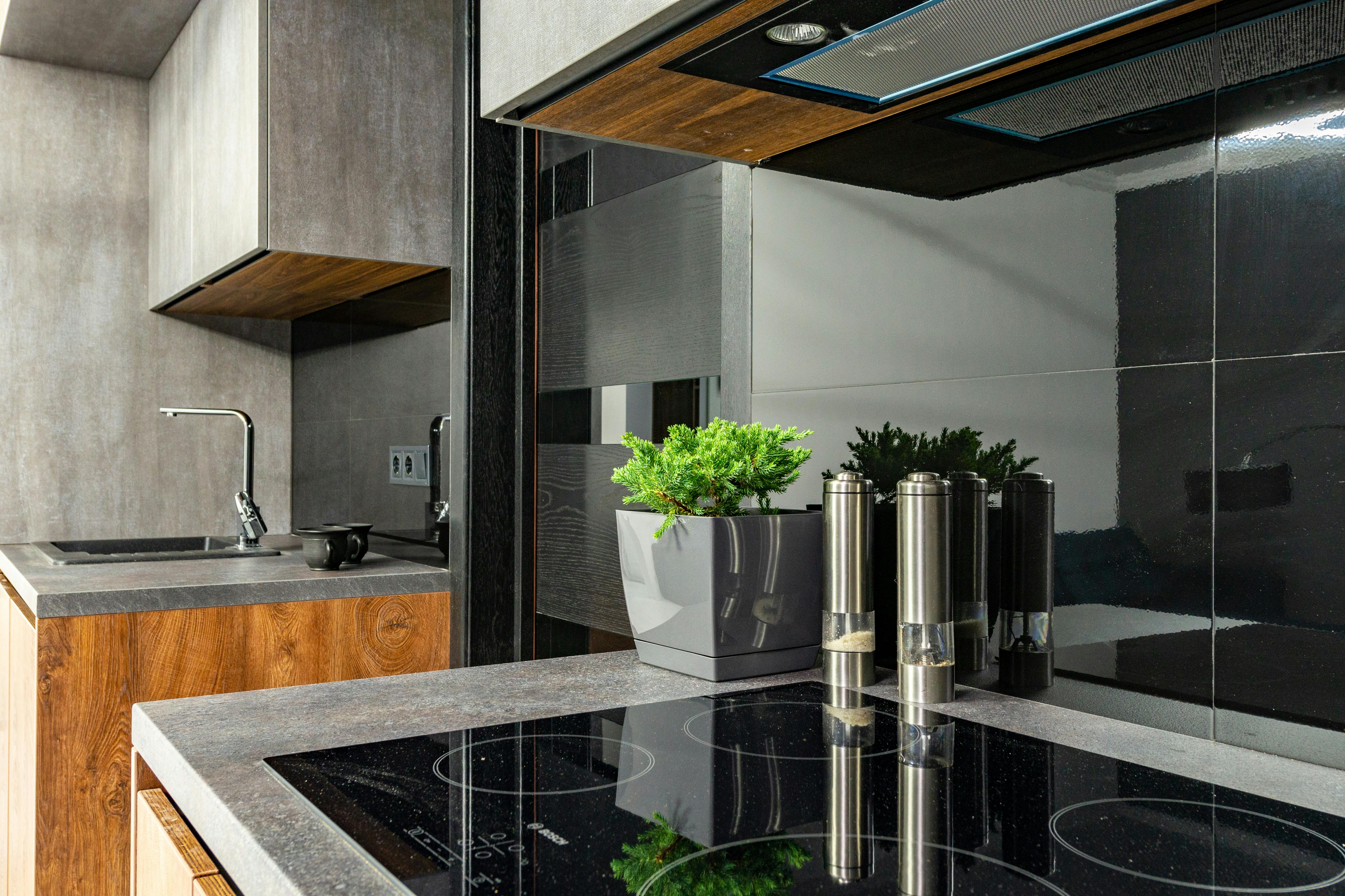Sleek induction cooktop in a modern home kitchen, showing how electric appliances change the cost comparison between gas and electric homes.