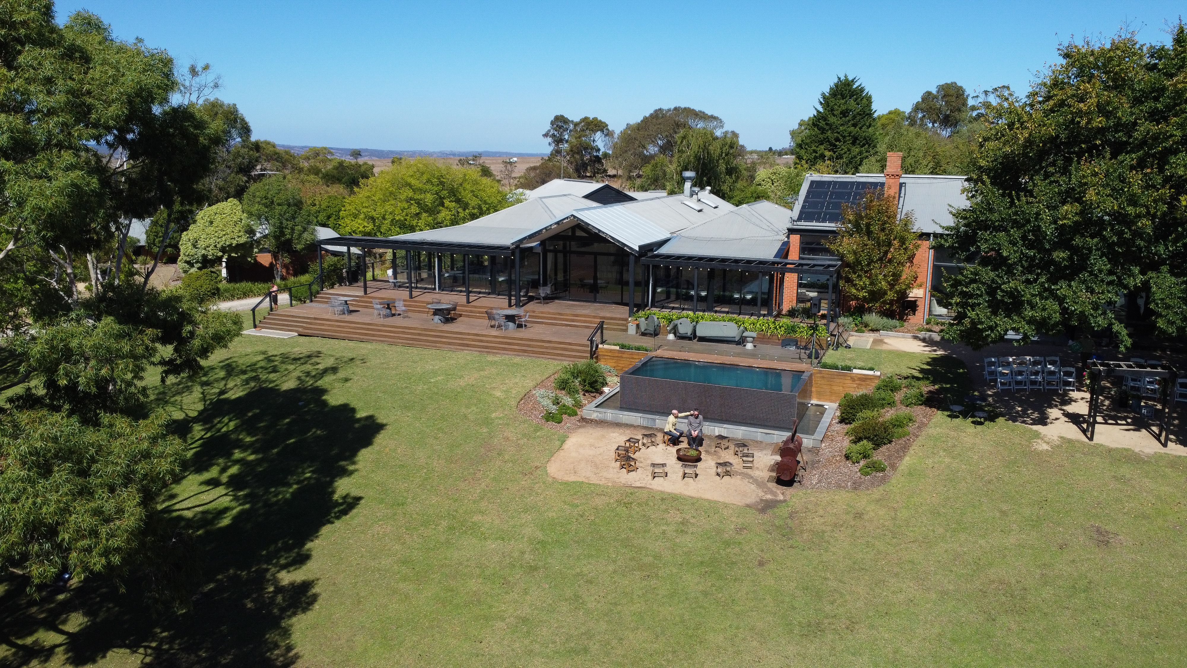 Aerial view of an Australian home with rooftop solar panels, showing how solar fits into a whole-of-home electrification plan.