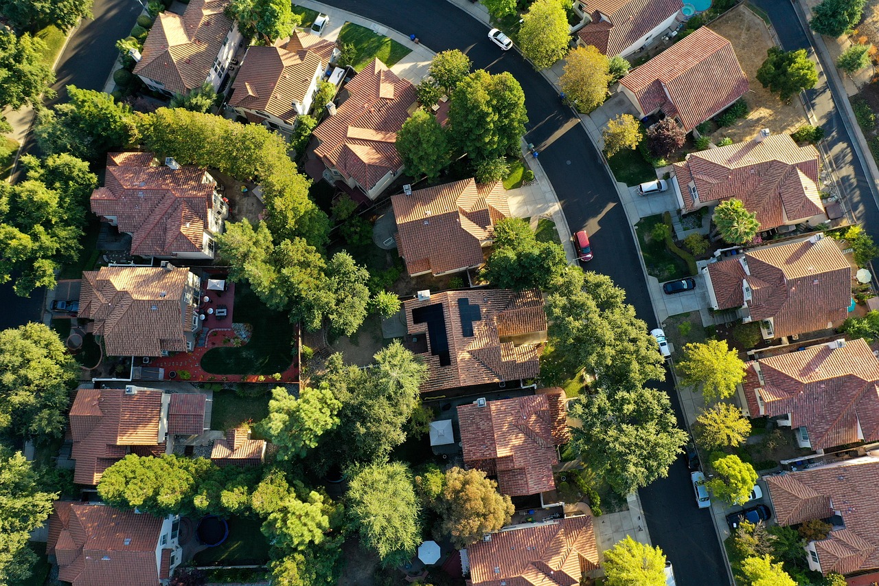 Aerial view of Australian rooftops fitted with solar panels, the residential setting where electrification cost versus savings decisions play out.