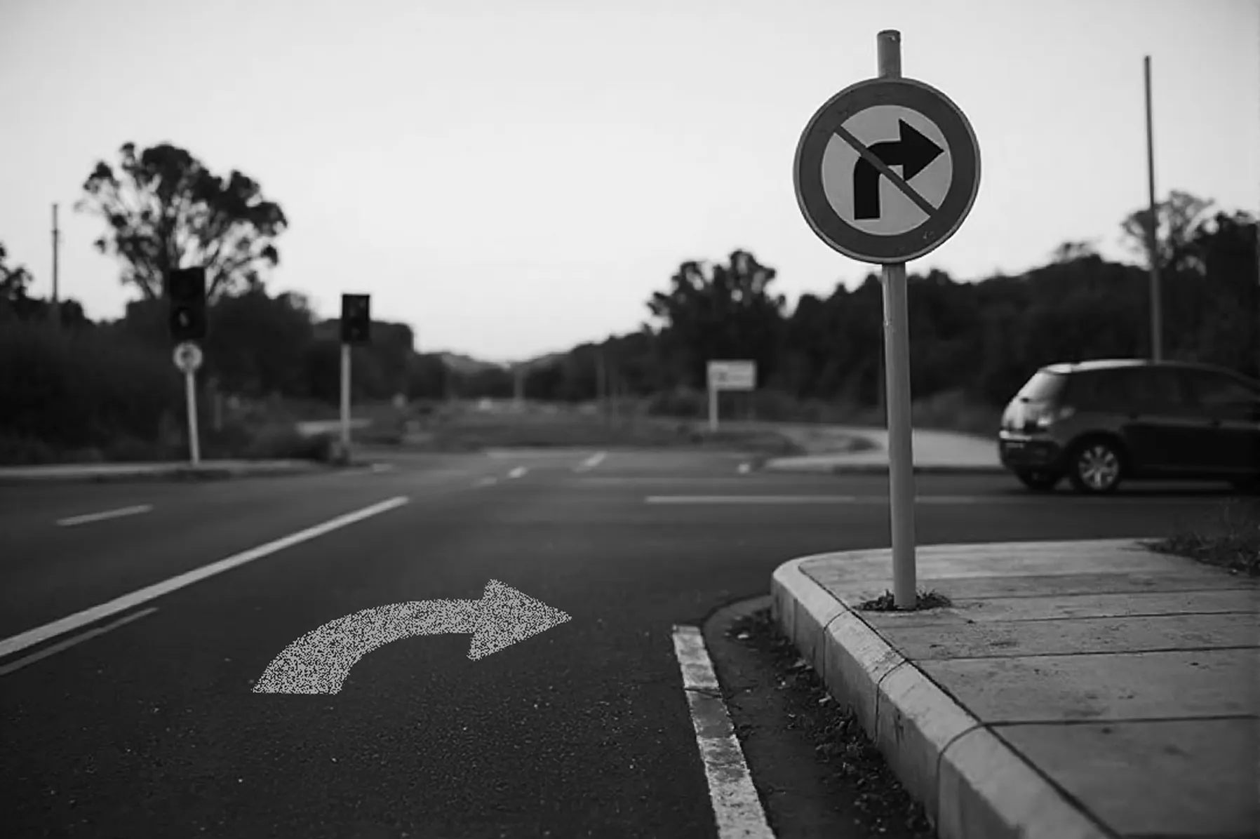 A car is turning right where a right-turn arrow is painted on the road, but a nearby sign prohibits right turns.