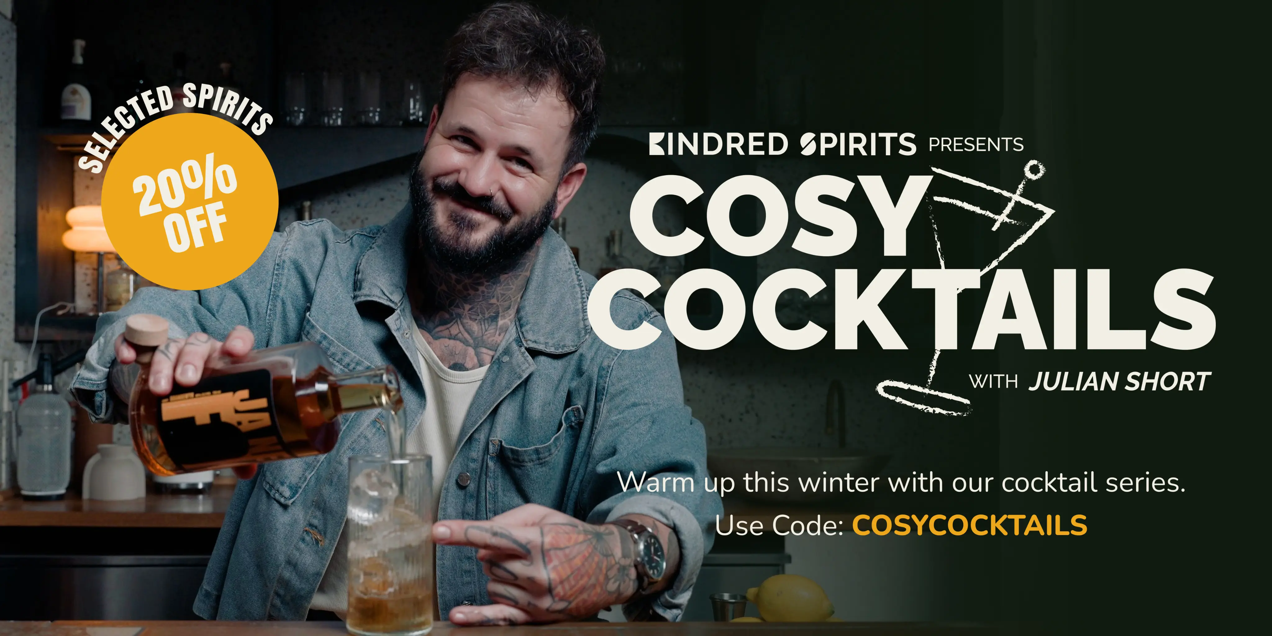 Julian Short pouring Ja Nee Fok brandy drink into a glass, promoting cosy cocktails with 20% off selected spirits at Kindred Spirits.