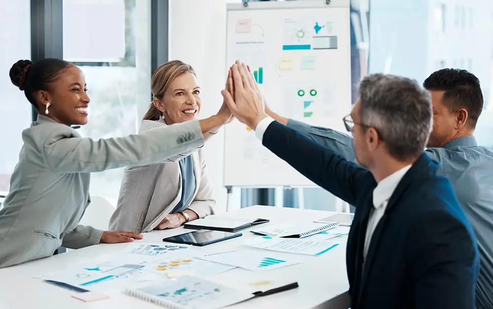 Group of neuroleadership staff members high fiving