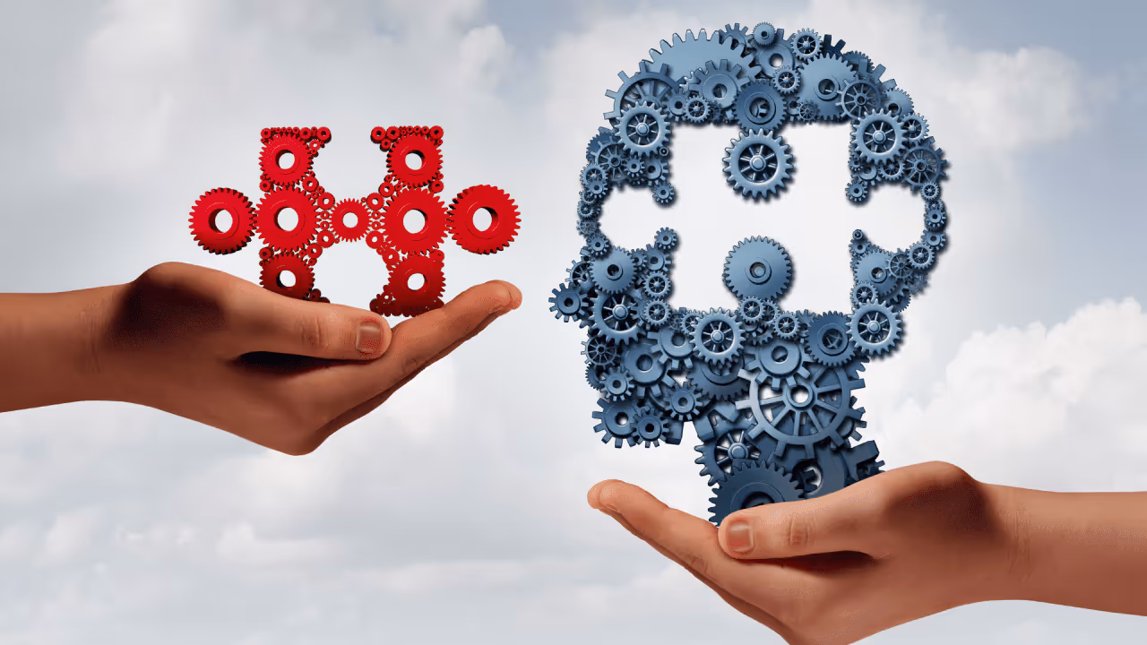 2 hands, one holding a jigsaw piece and the other holding a head with a space missing