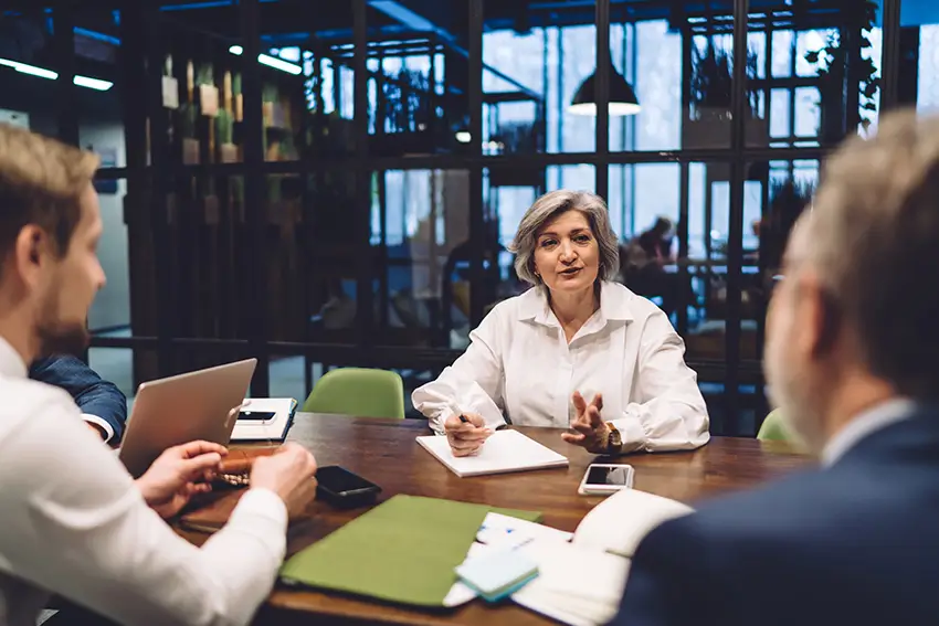 Neuromanagment staff working together around an office desk