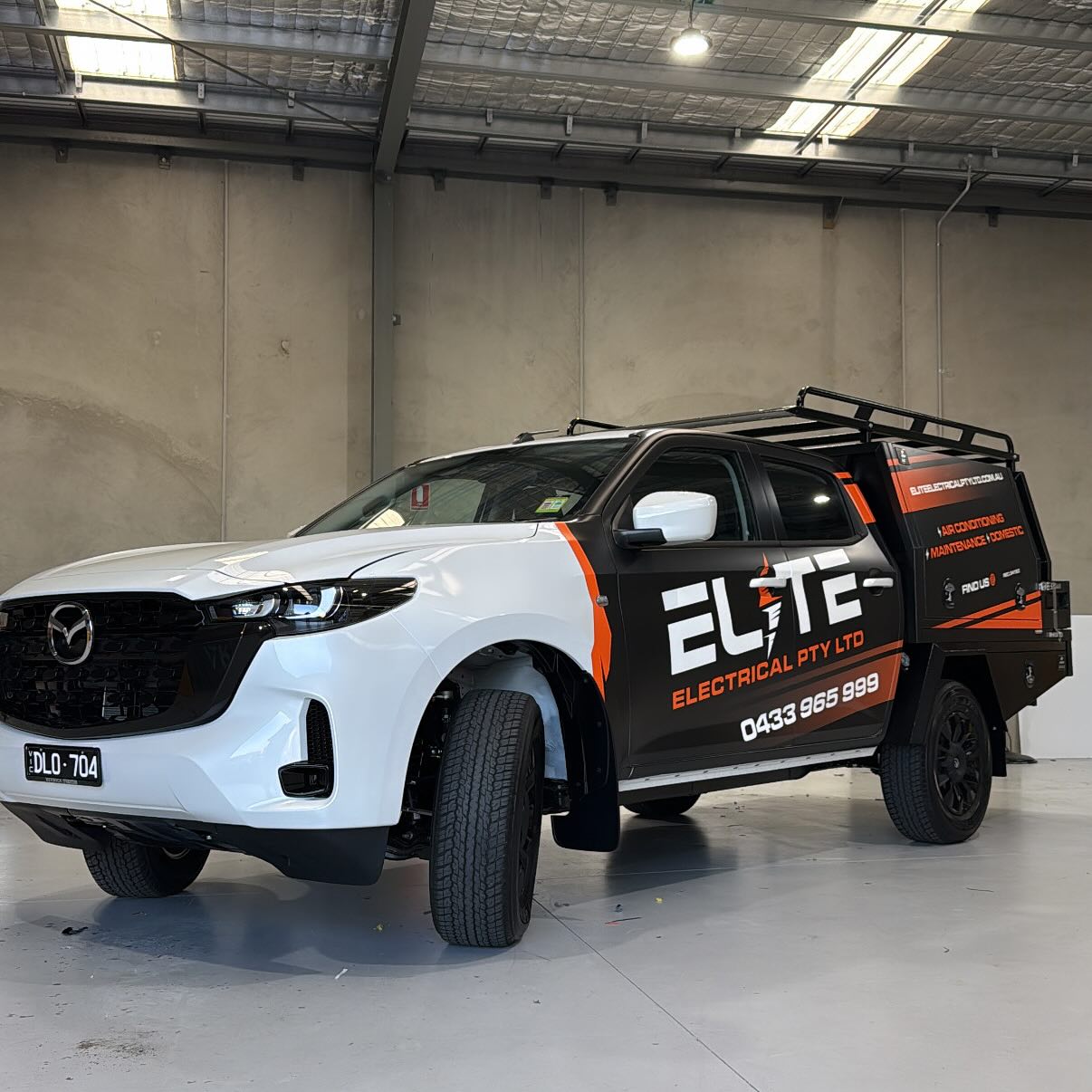 Elite Electrical branded work vehicle inside a warehouse