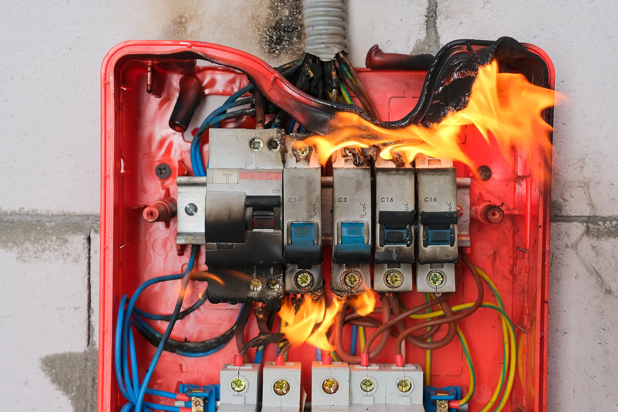 Electrician’s hand wiring a wall socket during residential installation