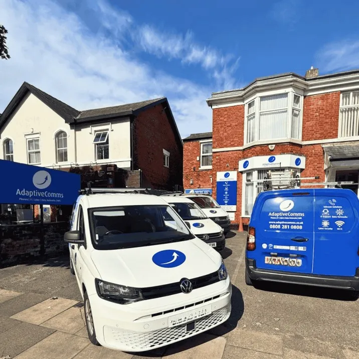 AdaptiveComms headquarters with branded service vans outside the Southport office