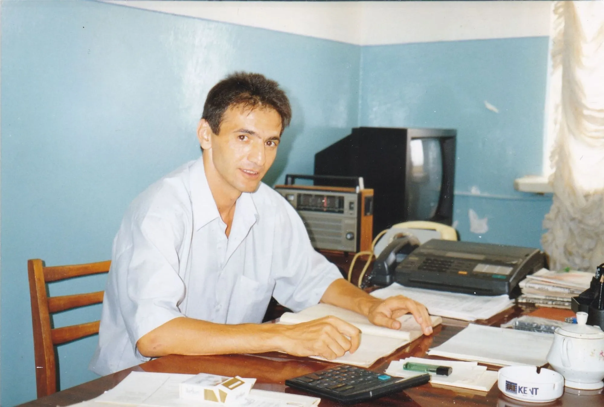 A man sitting at a desk in front of a computer.